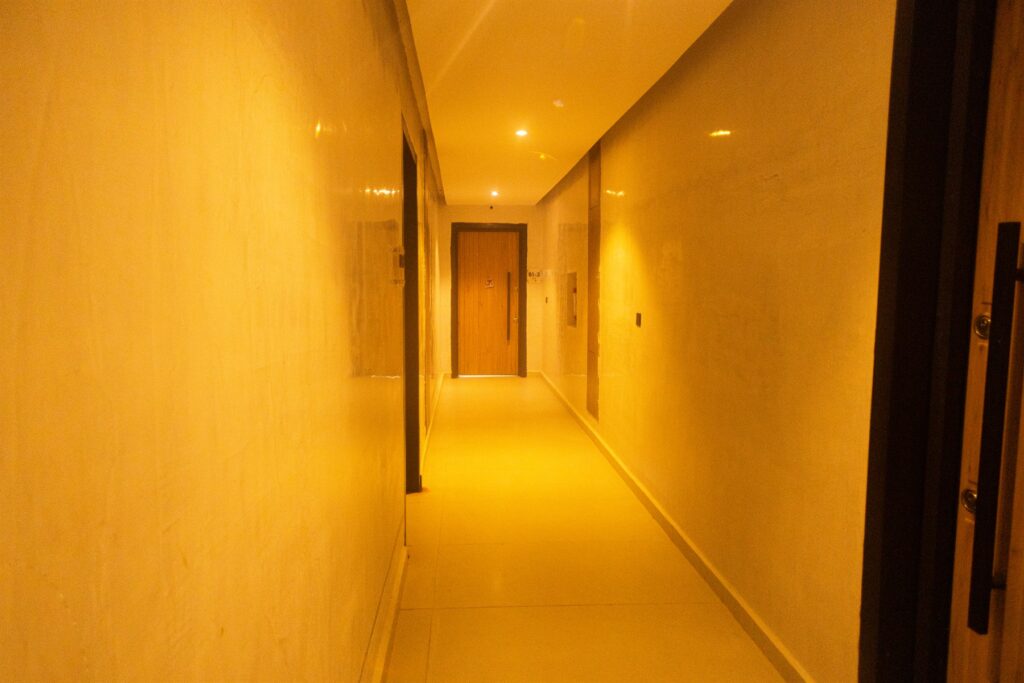 Brum Height 7: Internal corridor with warm recessed lighting